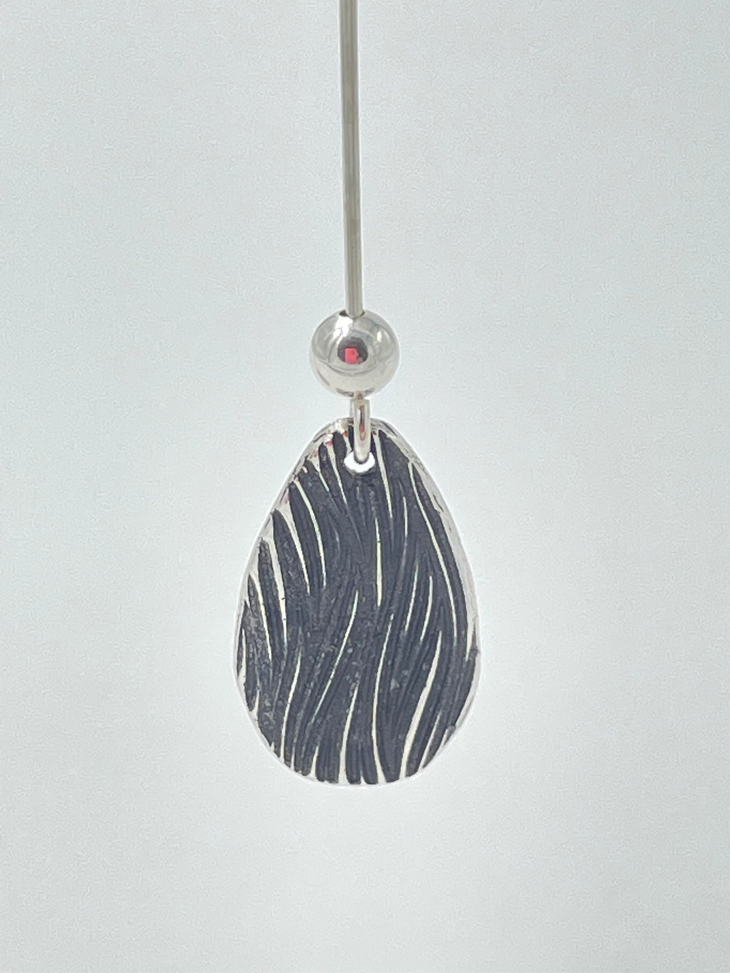 Handmade silver teardrop earrings with silver bead.