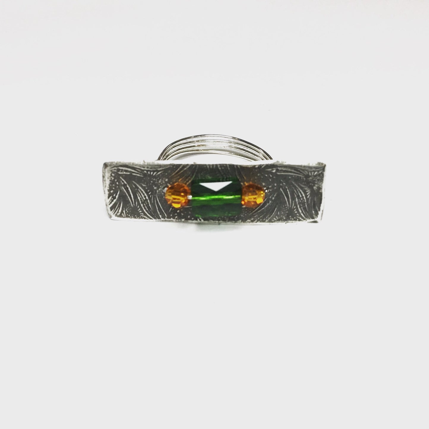 Silver ring with emerald and topaz Swarovski crystals.