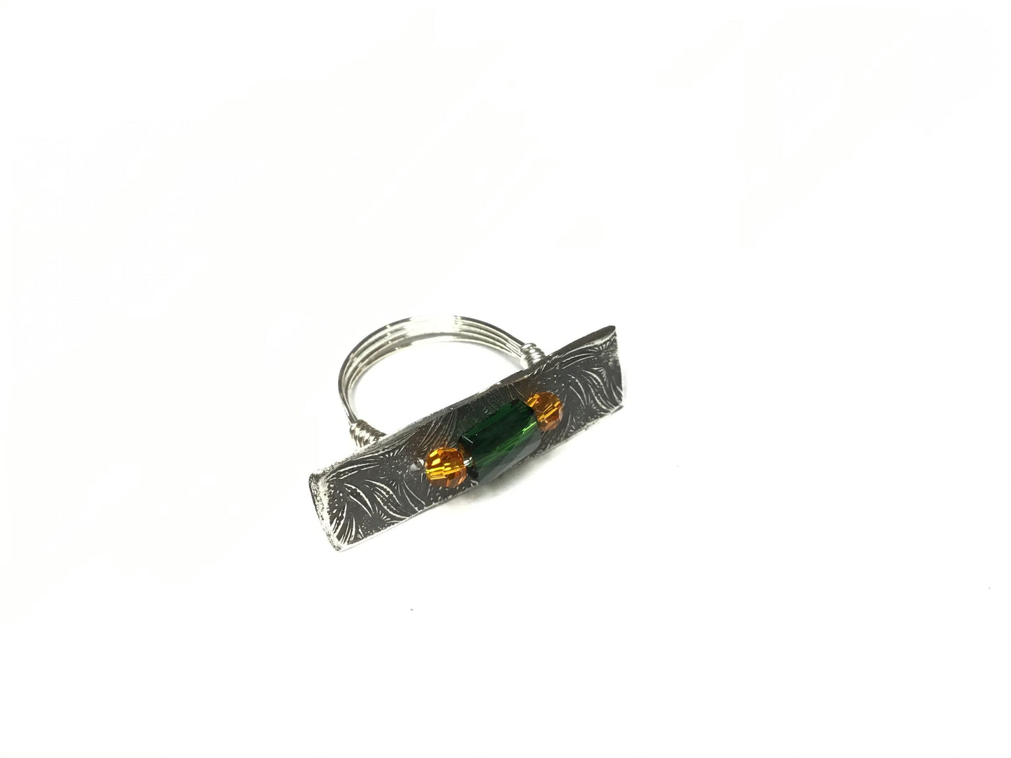 Silver ring with emerald and topaz Swarovski crystals.